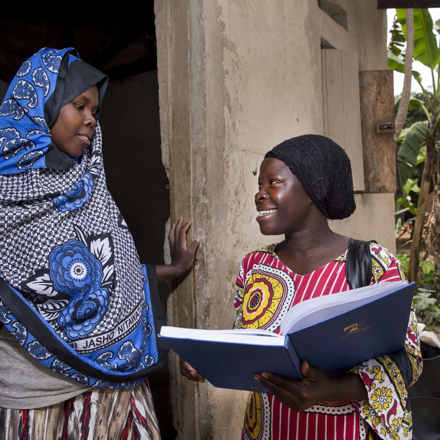 Community health worker during a home visit, providing family planning services and options to women in the community. This proactive program is supported by Reproductive Health Uganda.