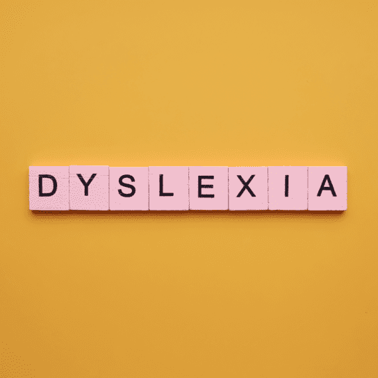 Dyslexia Dyslexia word wooden cubes on an yellow background