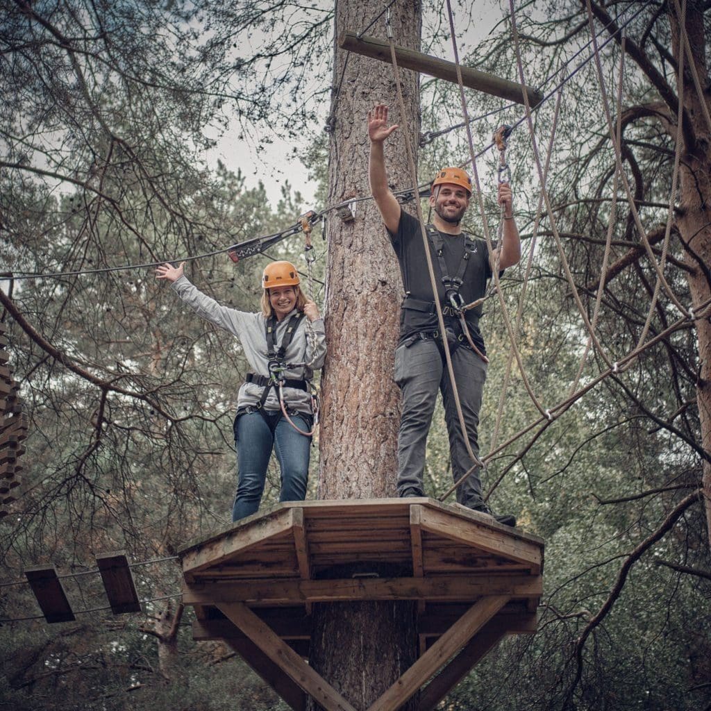 Senior Solutions Consulant Jenny and Customer Success Manager Tom braving the treetops