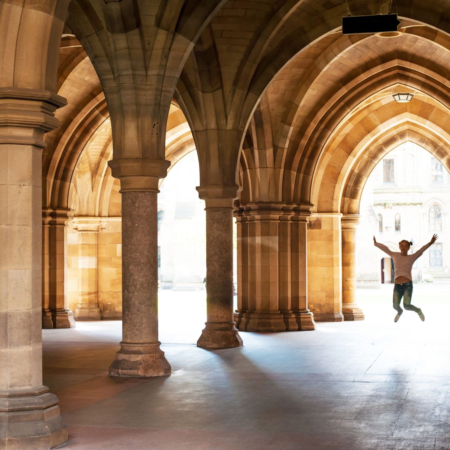 Silhouette,Of,Happy,Girl,Jumping,High,Up,In,Cloisters,Of